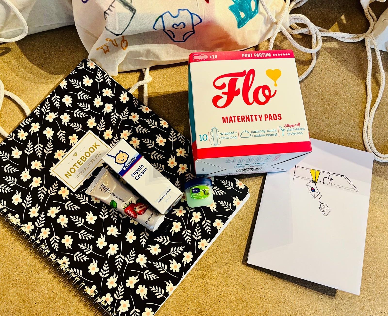 Maternity pads, a notebook and toiletries prepared for a hospital bag